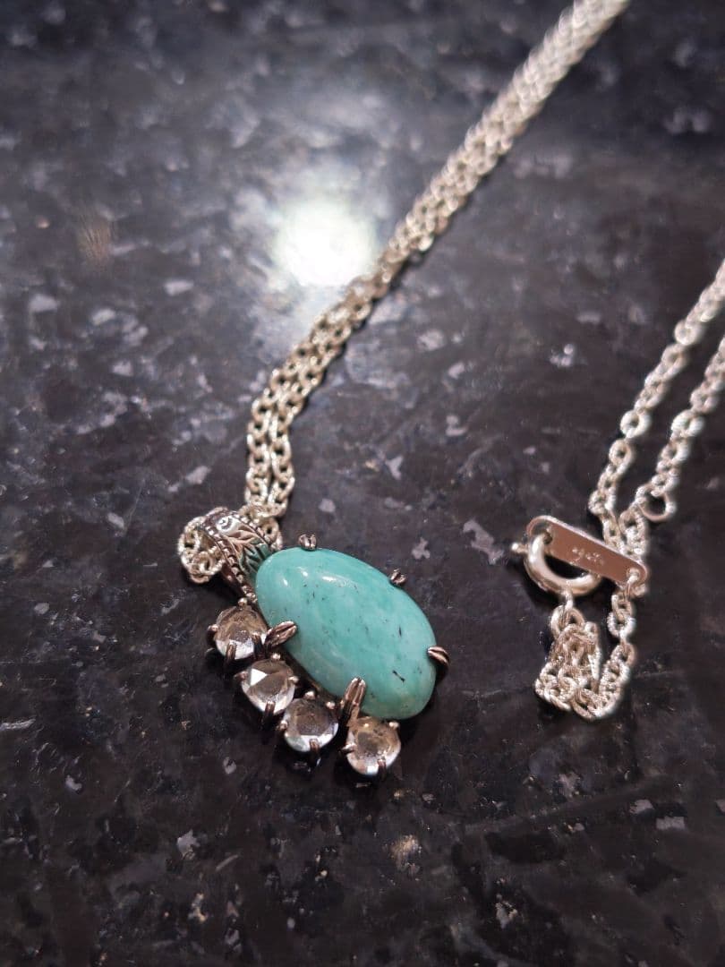 Agete silver necklace with turquoise stone and clear white topaz decorations on a delicate chain