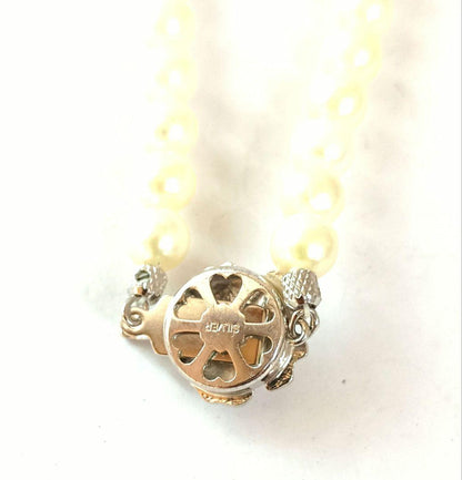 Single-strand Akoya pearl necklace with silver flower motif clasp, creamy white pearls approximately 6.5-6.7 mm diameter