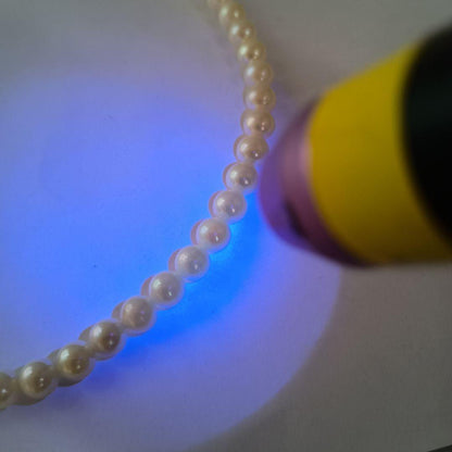 Single-strand Akoya pearl necklace with silver flower motif clasp, creamy white pearls approximately 6.5-6.7 mm diameter