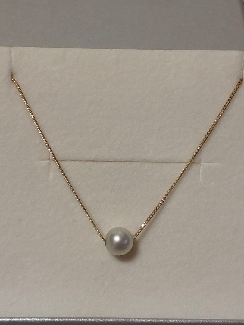 Tasaki K18 Pearl Necklace featuring lustrous pearls and 18 karat gold chain with brand markings