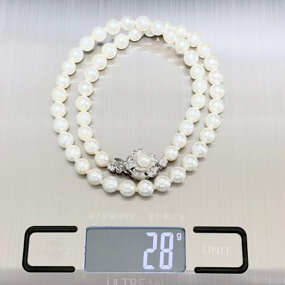 Akoya genuine pearl necklace with 6.4-6.9mm white pearls and silver SV clasp laid out on a white background