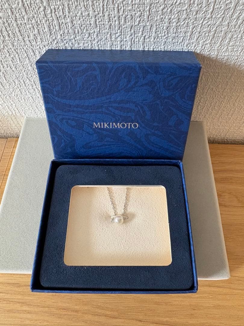 Mikimoto single pearl necklace with 6mm pearl and 40cm silver chain on white background