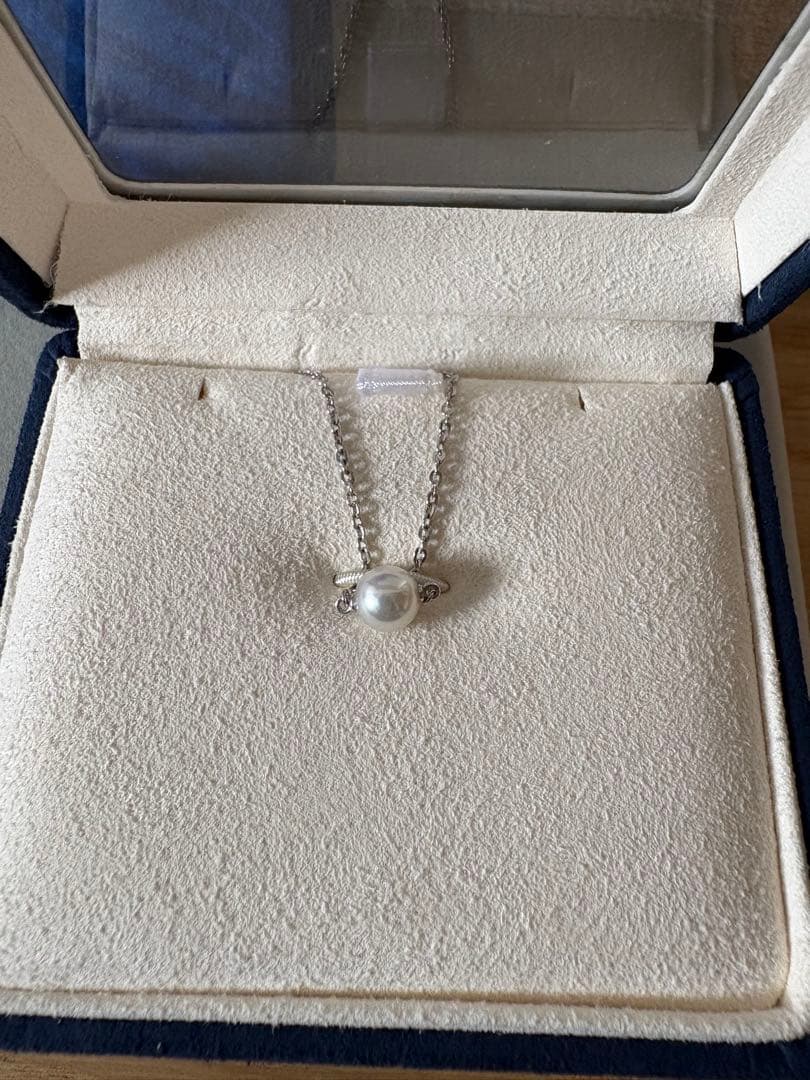 Mikimoto single pearl necklace with 6mm pearl and 40cm silver chain on white background