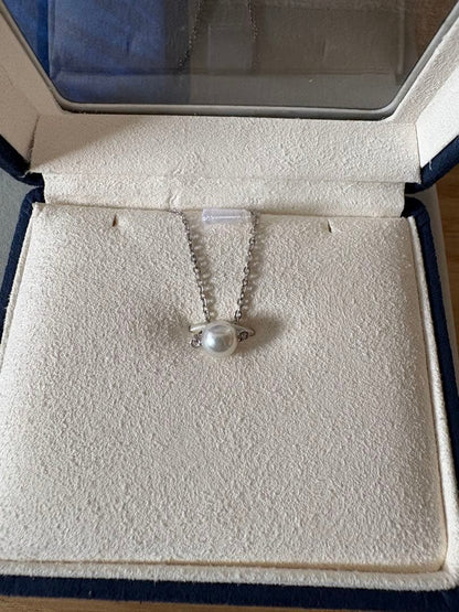 Mikimoto single pearl necklace with 6mm pearl and 40cm silver chain on white background