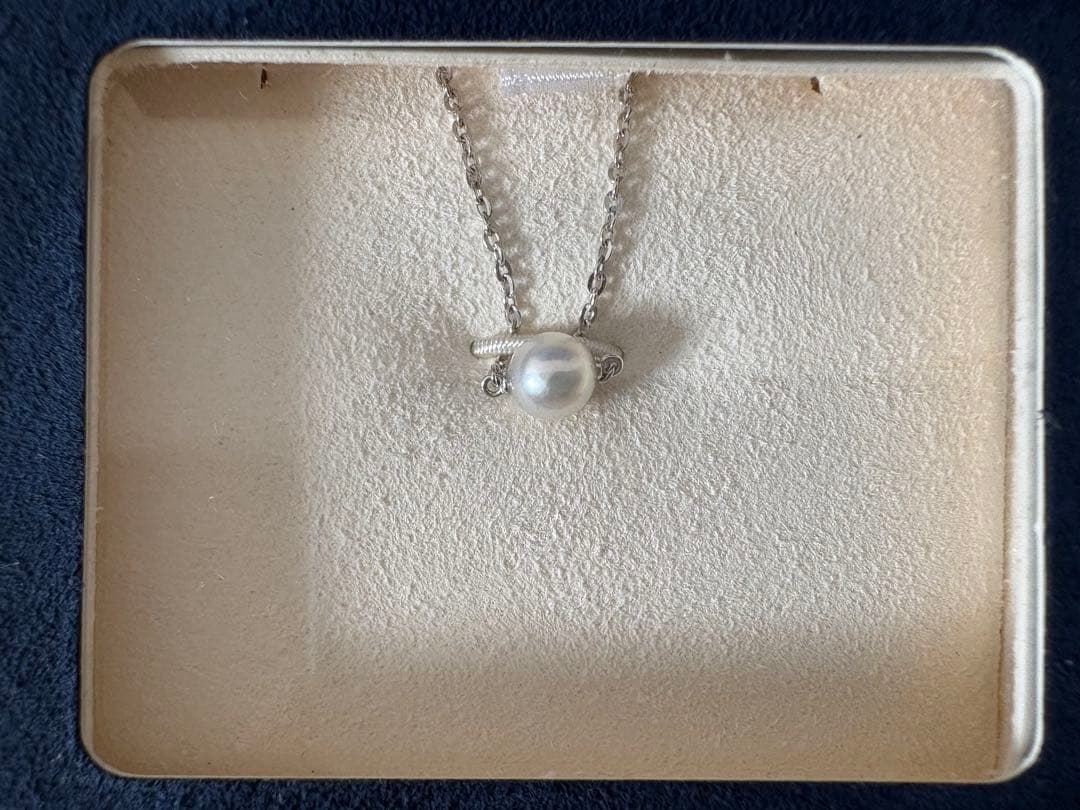 Mikimoto single pearl necklace with 6mm pearl and 40cm silver chain on white background
