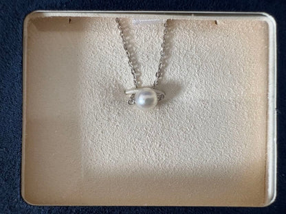 Mikimoto single pearl necklace with 6mm pearl and 40cm silver chain on white background