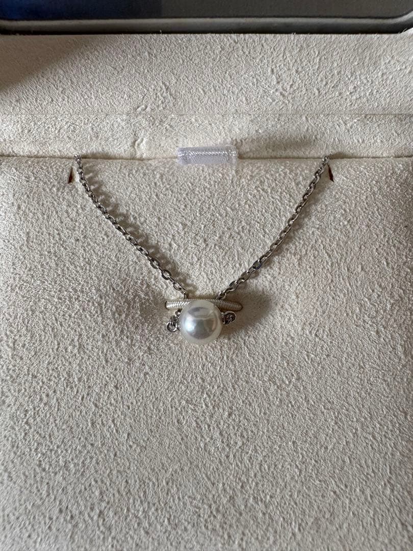 Mikimoto single pearl necklace with 6mm pearl and 40cm silver chain on white background