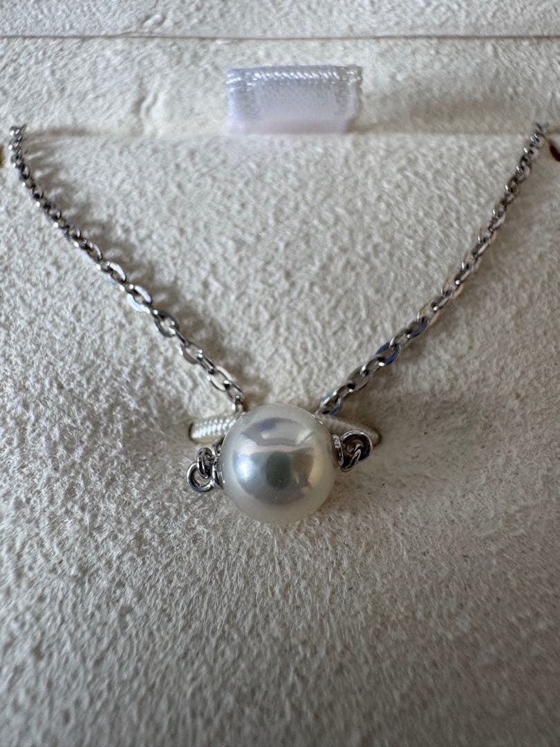 Mikimoto single pearl necklace with 6mm pearl and 40cm silver chain on white background
