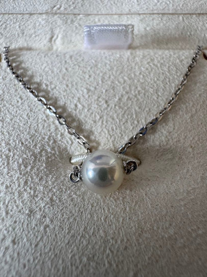 Mikimoto single pearl necklace with 6mm pearl and 40cm silver chain on white background