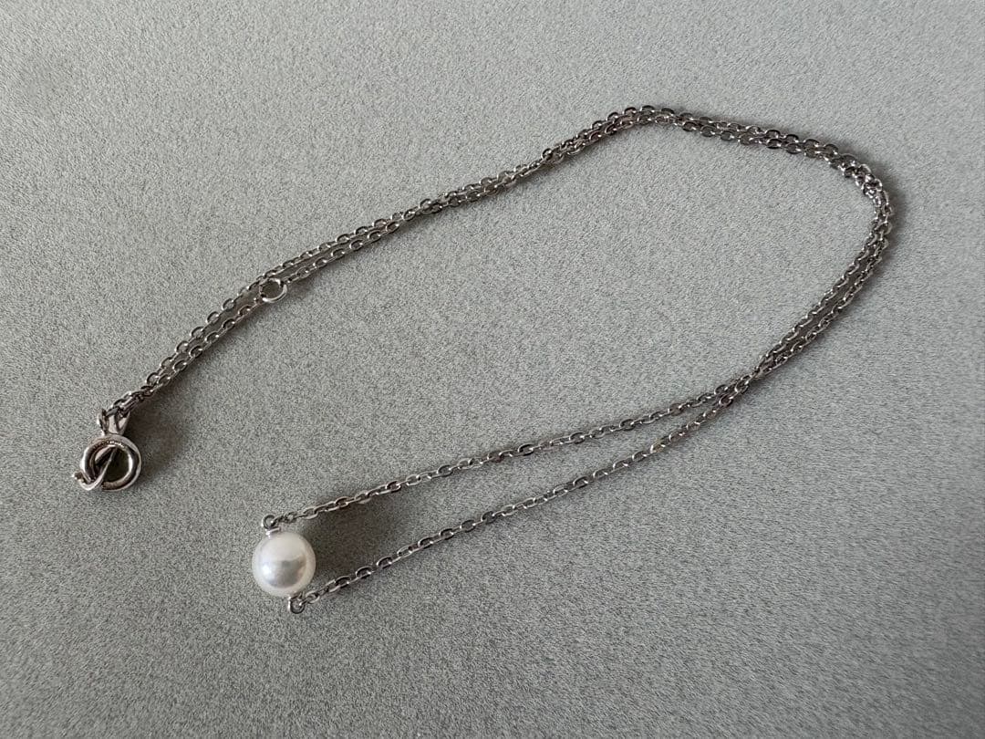 Mikimoto single pearl necklace with 6mm pearl and 40cm silver chain on white background