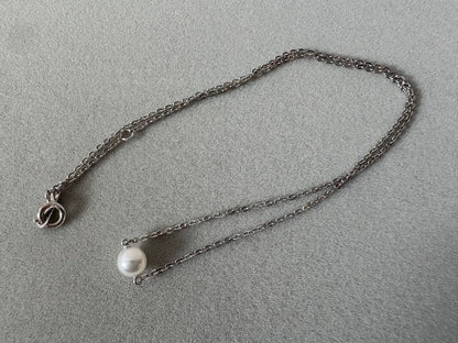 Mikimoto single pearl necklace with 6mm pearl and 40cm silver chain on white background