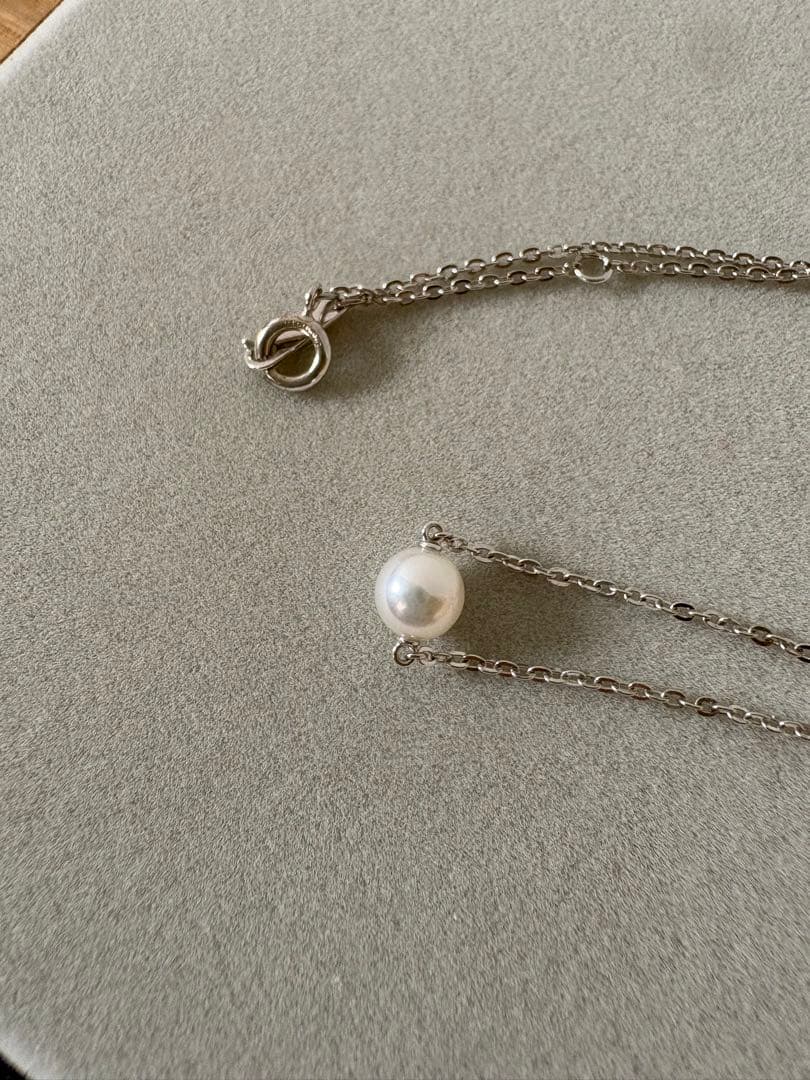 Mikimoto single pearl necklace with 6mm pearl and 40cm silver chain on white background
