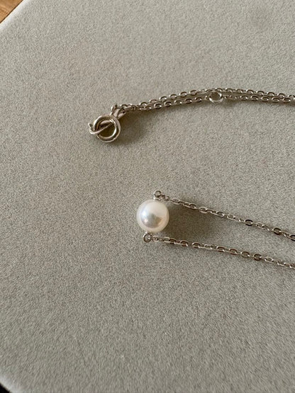 Mikimoto single pearl necklace with 6mm pearl and 40cm silver chain on white background