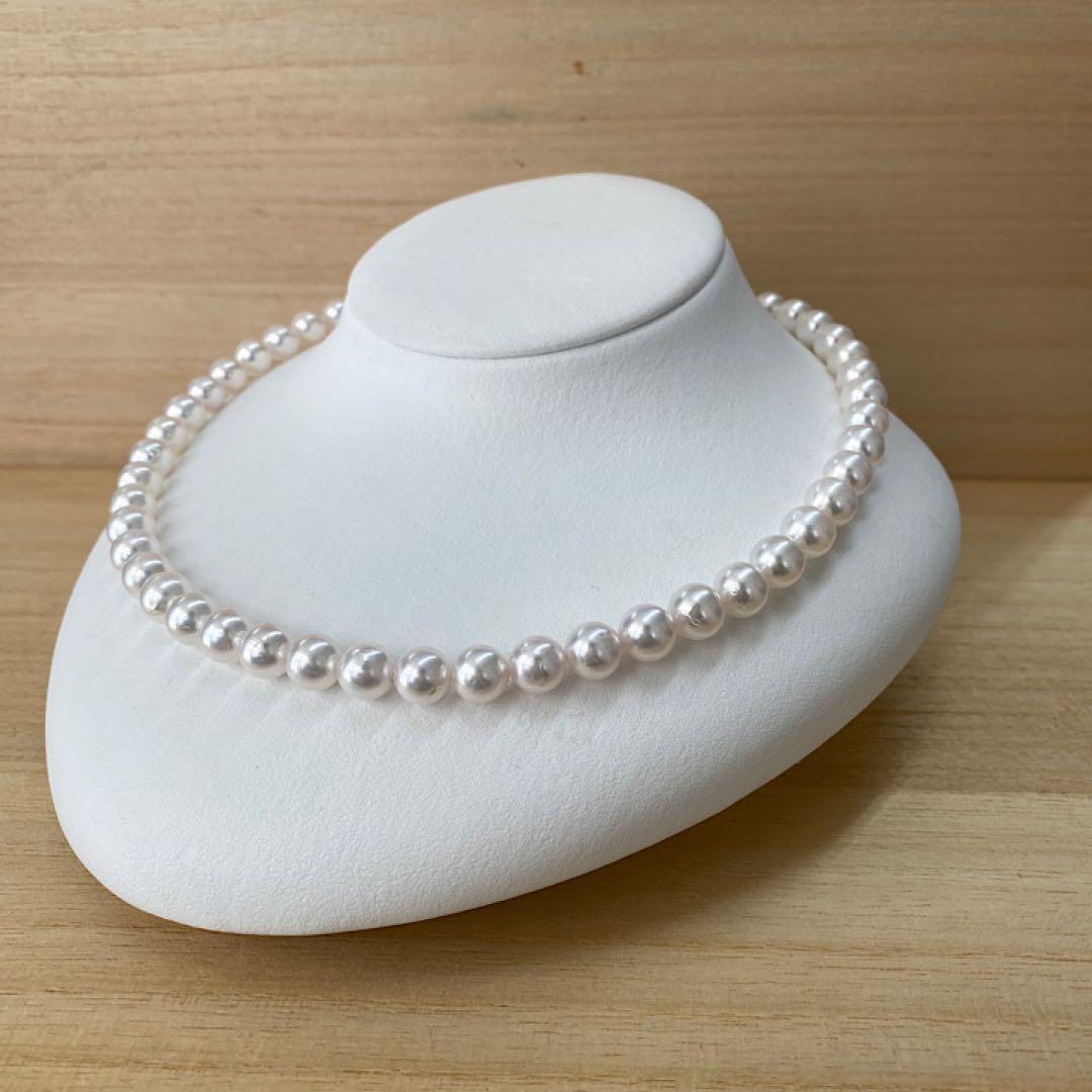 Akoya pearl necklace with 49 iridescent pearls sized 8.0-8.5mm and silver one-touch clasp on white background