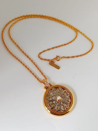 Mikimoto pendant necklace featuring a gold and silver pendant with magnifier on a 64 cm gold chain