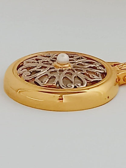 Mikimoto pendant necklace featuring a gold and silver pendant with magnifier on a 64 cm gold chain