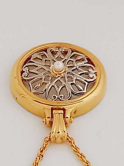 Mikimoto pendant necklace featuring a gold and silver pendant with magnifier on a 64 cm gold chain