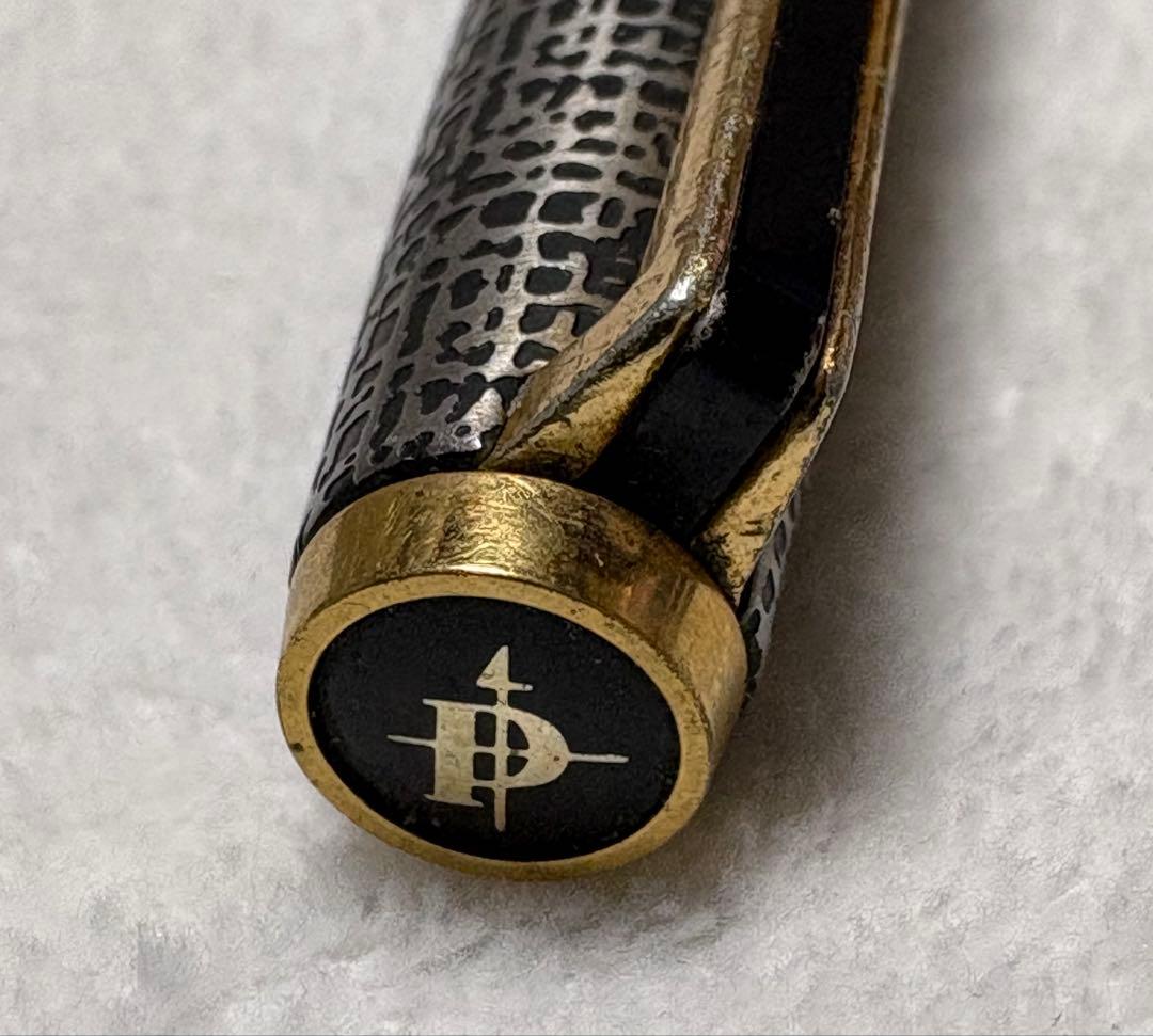 Used Pilot fountain pen with gold trim and geometric pattern, 18 karat nib, showing scratches and name engraving