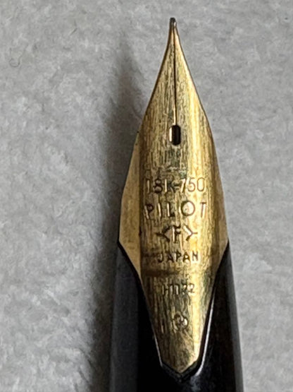 Used Pilot fountain pen with gold trim and geometric pattern, 18 karat nib, showing scratches and name engraving
