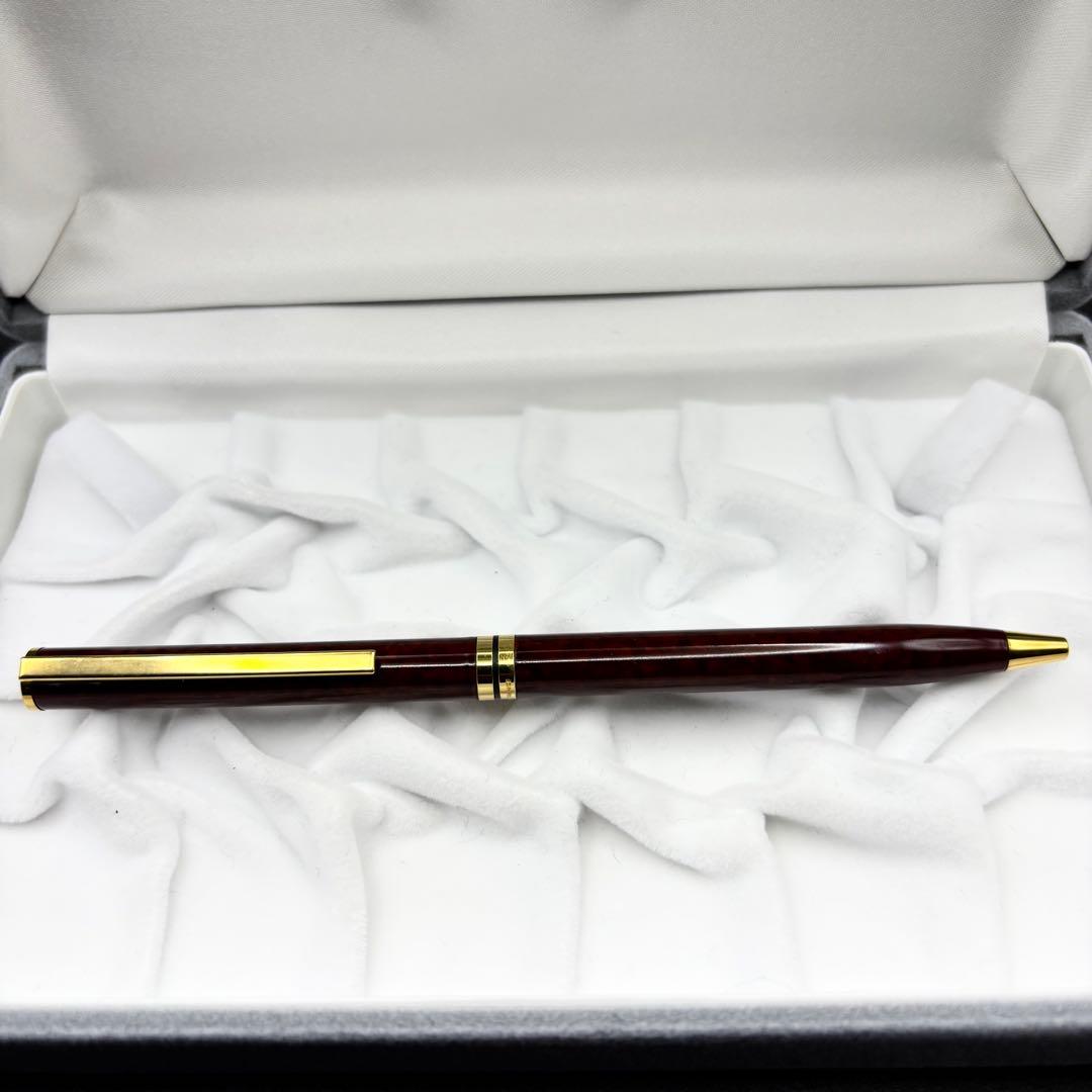Vintage Waterman ballpoint pen with brown marble pattern and gold accents, rotary mechanism, made in France