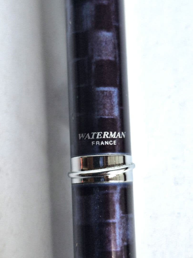 Waterman ballpoint pen with blue and black marble pattern and simple clip on metal and plastic body