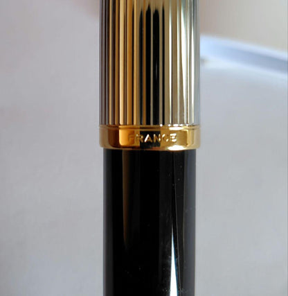 Waterman ballpoint pen with company name marking, unused with slight discoloration on clip