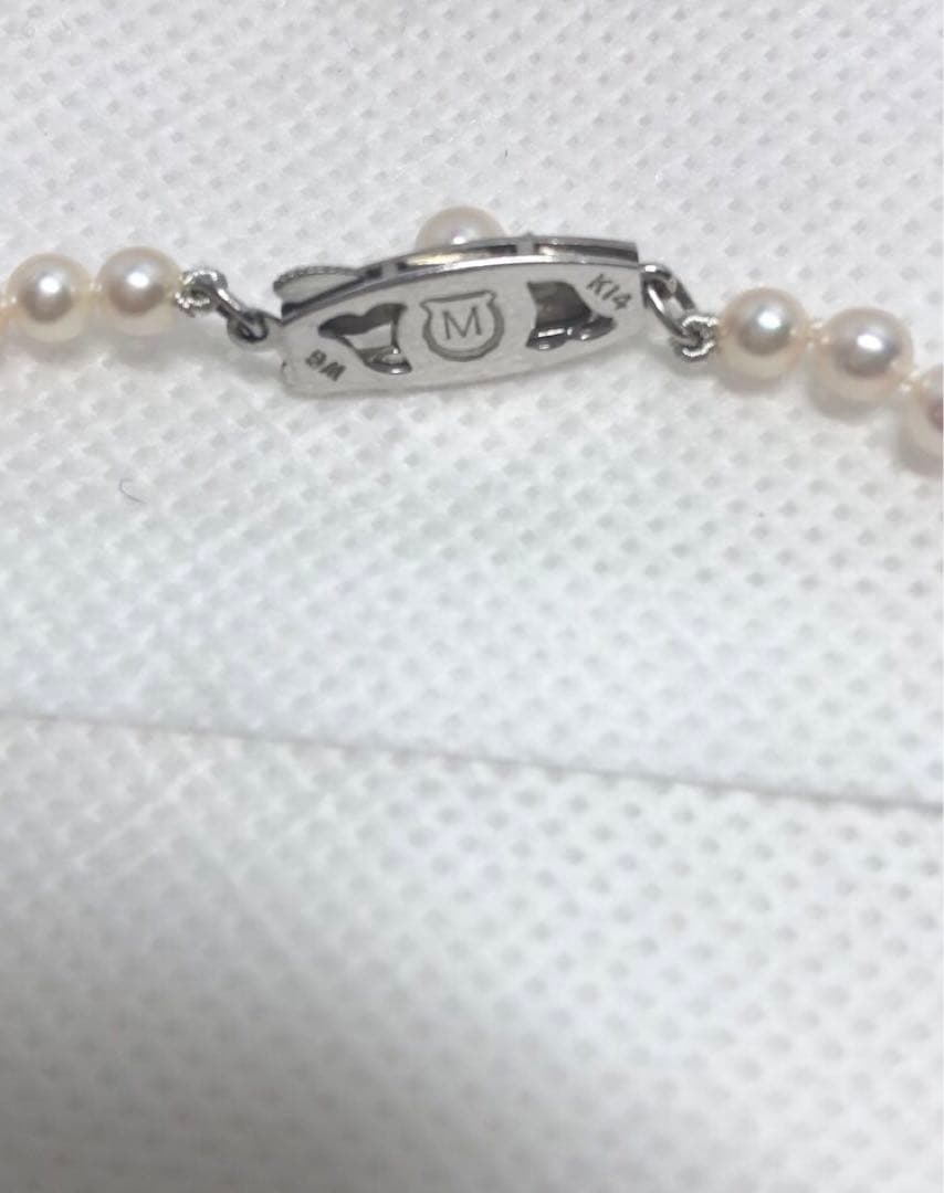 K14wg Mikimoto Akoya baby pearl necklace with gradient sized pearls and 44 cm length on white background