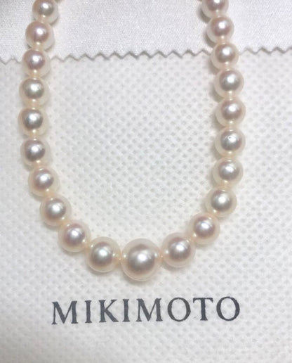 K14wg Mikimoto Akoya baby pearl necklace with gradient sized pearls and 44 cm length on white background