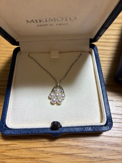 MIKIMOTO Pearl Necklace with silver material and incised silver case shown on white background