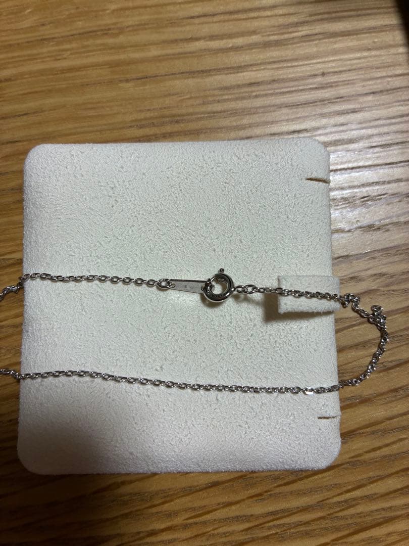 MIKIMOTO Pearl Necklace with silver material and incised silver case shown on white background