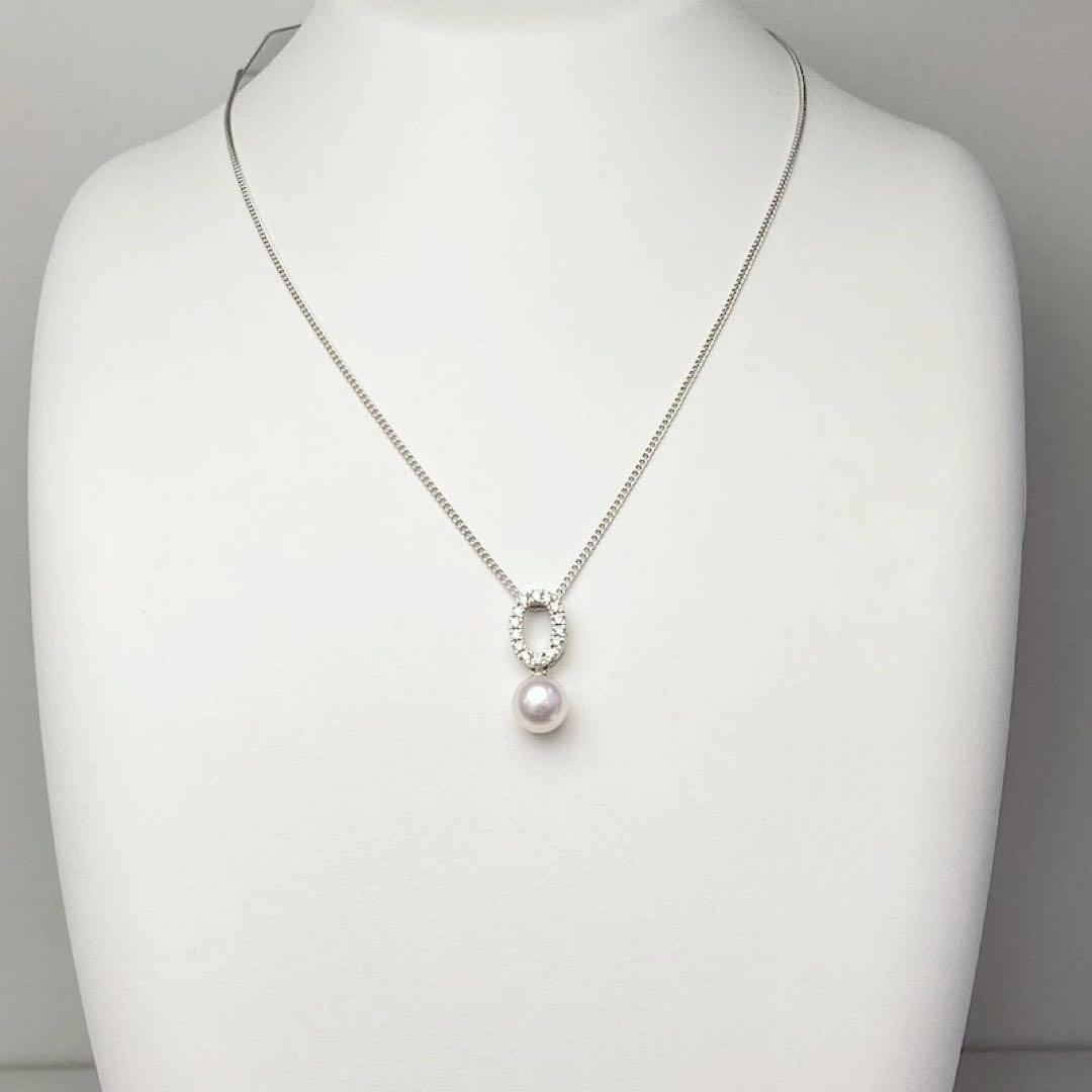 Akoya pearl pendant necklace with 7mm pearl, cubic zirconia accents, and silver 925 rhodium plated chain on white background