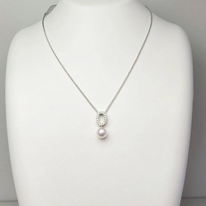 Akoya pearl pendant necklace with 7mm pearl, cubic zirconia accents, and silver 925 rhodium plated chain on white background