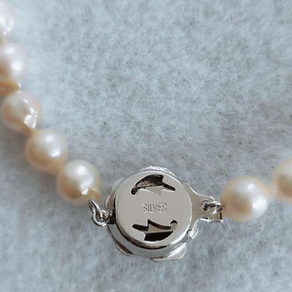 Akoya baroque pearl necklace in white with silver stamp, 42 cm length, displayed on a white background