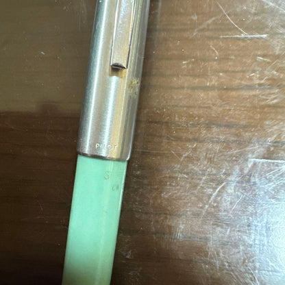 Used PILOT green fountain pen with visible scratches, discoloration, and paint peeling