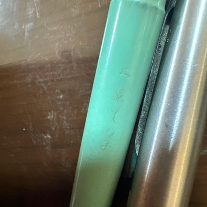 Used PILOT green fountain pen with visible scratches, discoloration, and paint peeling