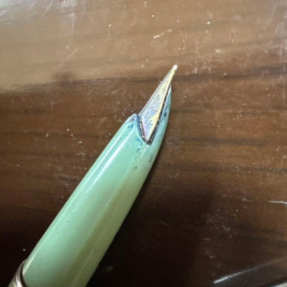 Used PILOT green fountain pen with visible scratches, discoloration, and paint peeling