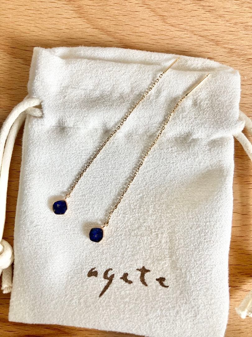 Gold dangling earrings with blue lapis lazuli stones in elegant design