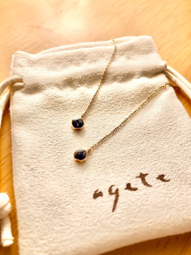 Gold dangling earrings with blue lapis lazuli stones in elegant design