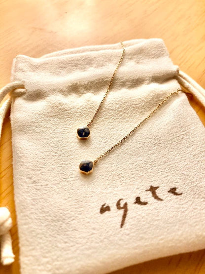 Gold dangling earrings with blue lapis lazuli stones in elegant design