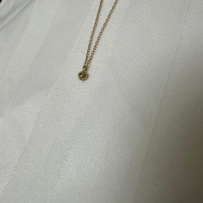 Close-up of Agate K18 18-karat gold necklace with 0.05ct diamond pendant