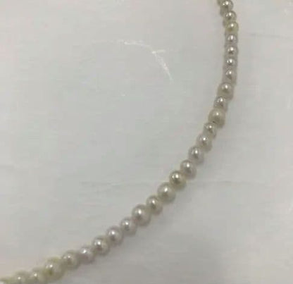 Akoya pearl baby necklace with small round pearls measuring 3.5 to 3.9mm on a 42cm chain