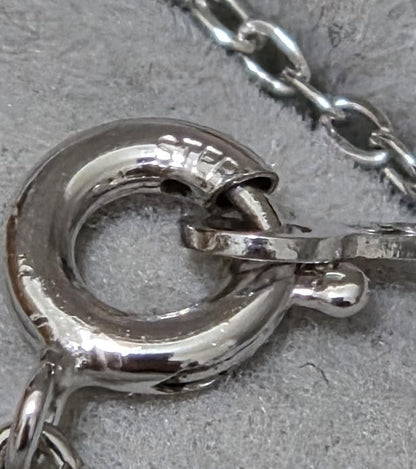 Close-up of Mikimoto 7mm pearl silver necklace with 40cm chain on a white background