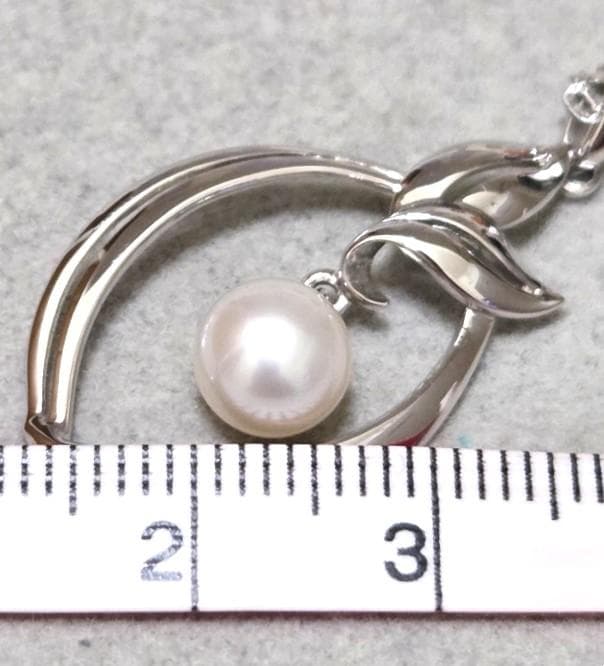 Close-up of Mikimoto 7mm pearl silver necklace with 40cm chain on a white background