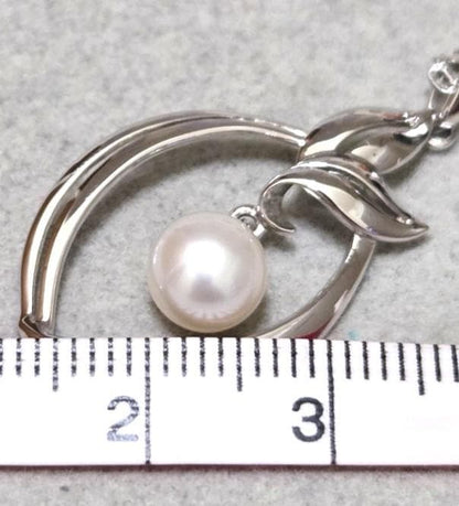 Close-up of Mikimoto 7mm pearl silver necklace with 40cm chain on a white background