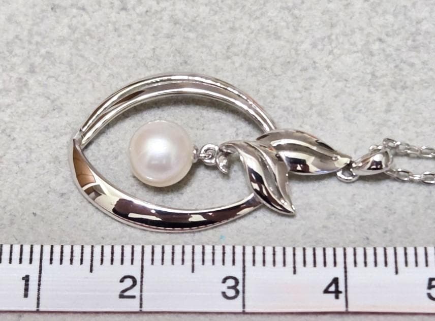 Close-up of Mikimoto 7mm pearl silver necklace with 40cm chain on a white background