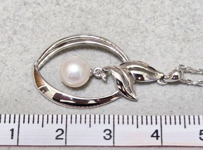 Close-up of Mikimoto 7mm pearl silver necklace with 40cm chain on a white background