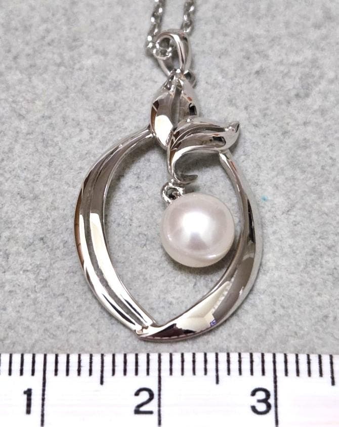 Close-up of Mikimoto 7mm pearl silver necklace with 40cm chain on a white background