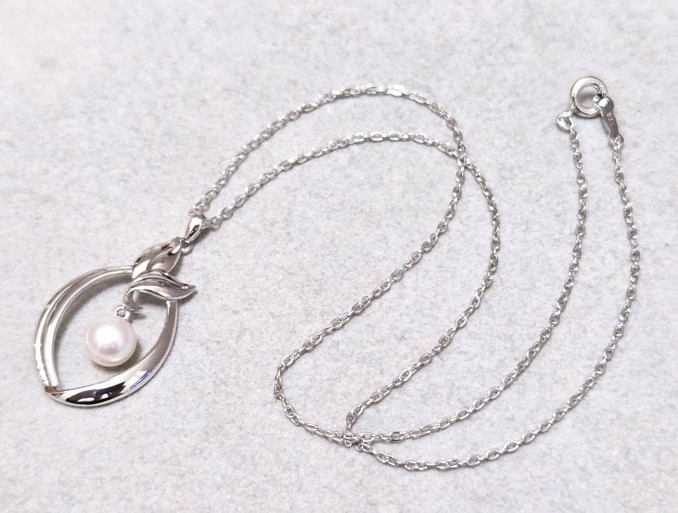 Close-up of Mikimoto 7mm pearl silver necklace with 40cm chain on a white background