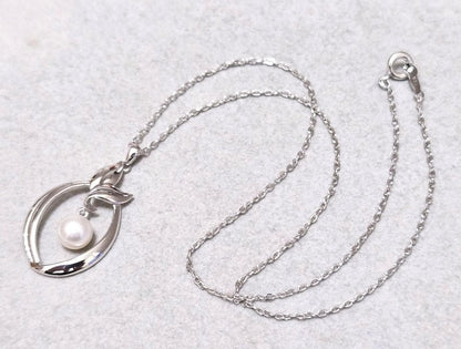 Close-up of Mikimoto 7mm pearl silver necklace with 40cm chain on a white background