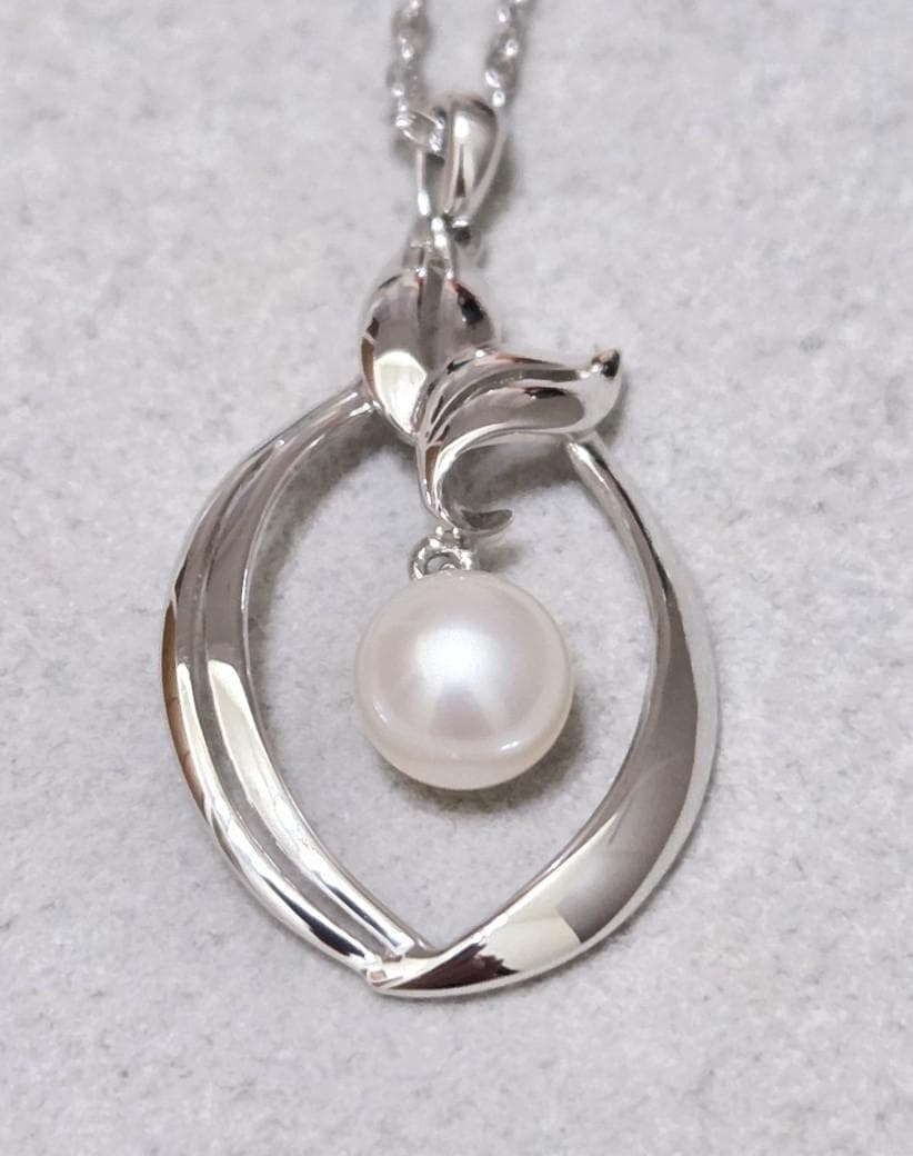Close-up of Mikimoto 7mm pearl silver necklace with 40cm chain on a white background